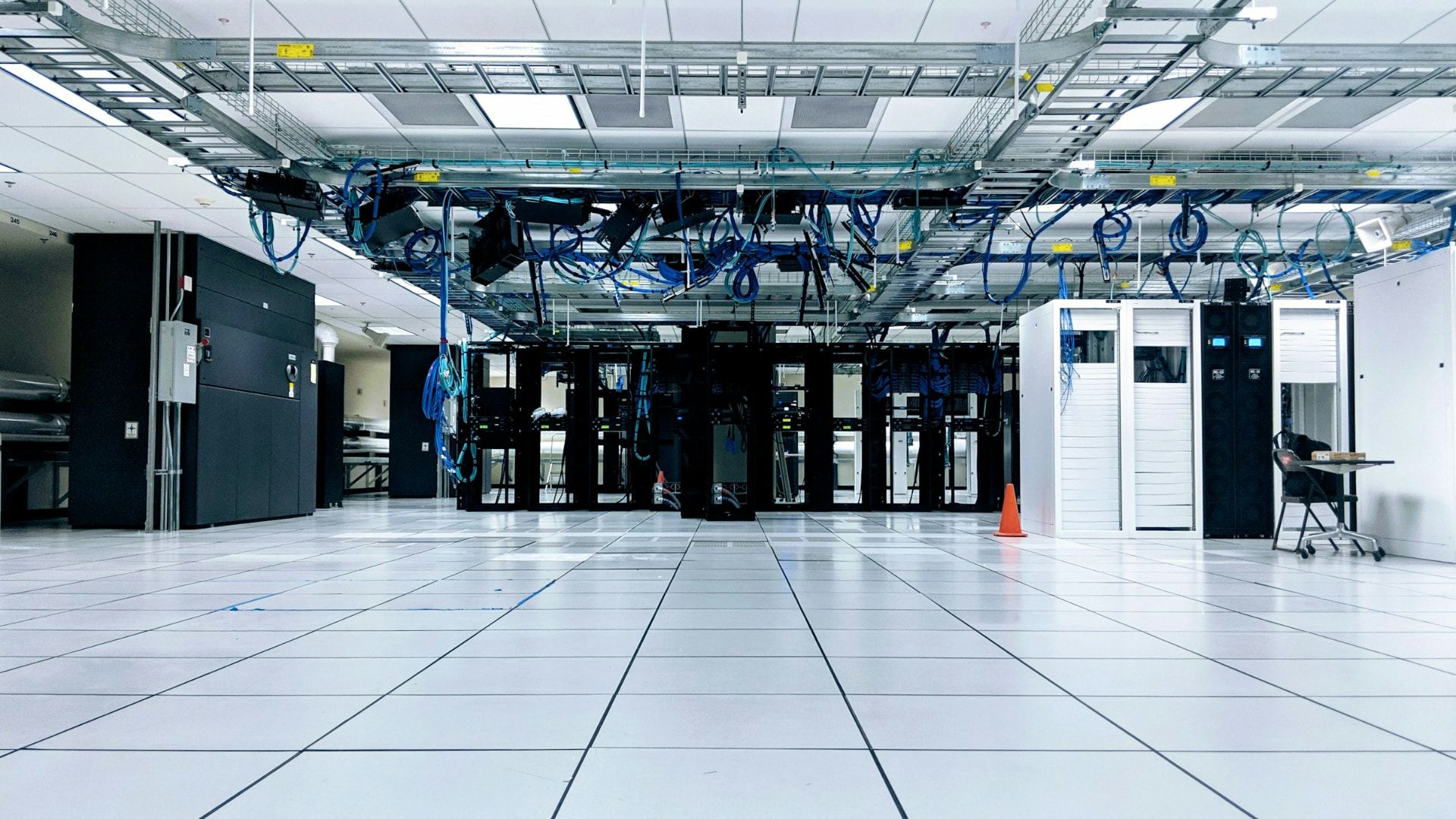 Data centre technical infrastructure with equipment racks and overhead cable containment